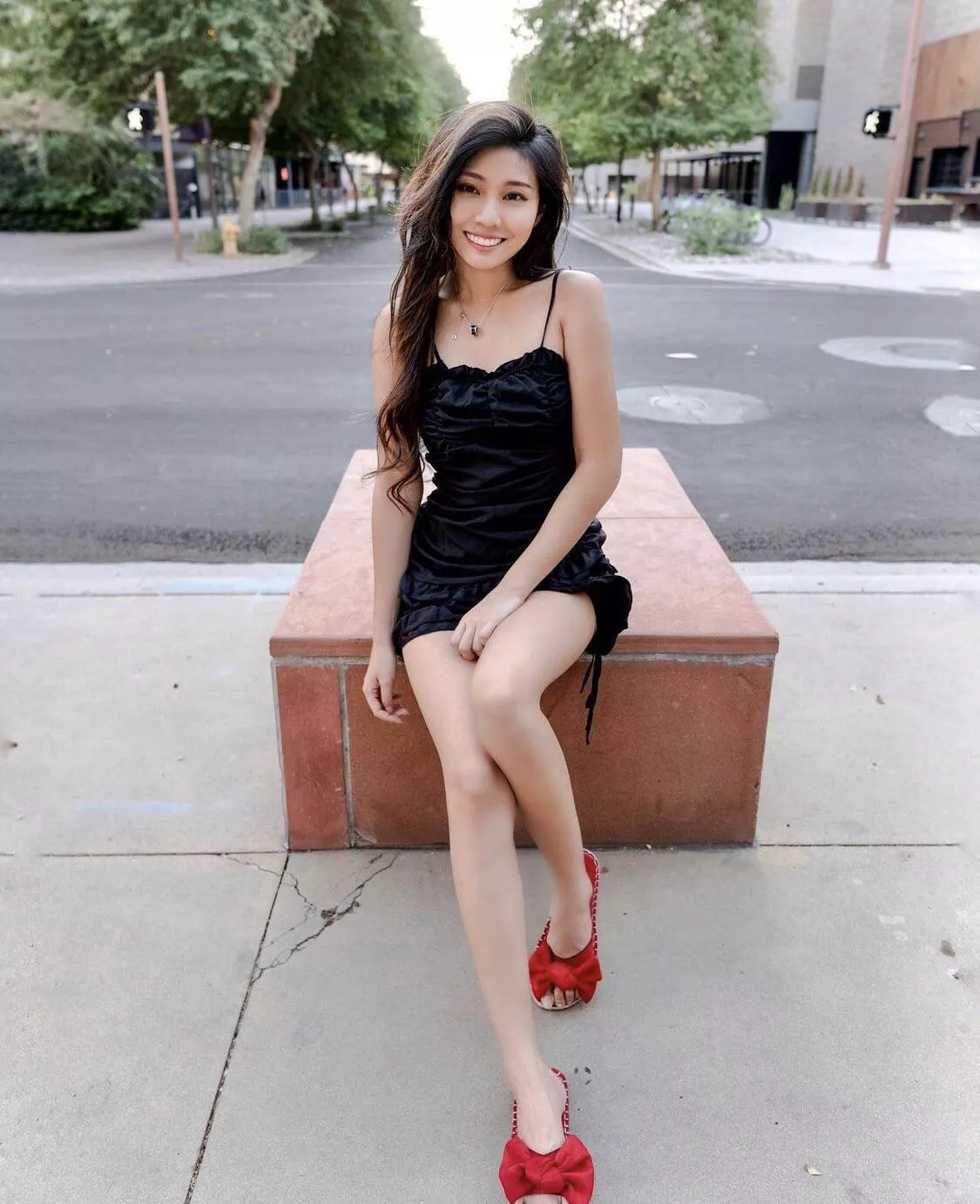 Asian girl in a black dress and red heels Asian girl in a black dress and red heels