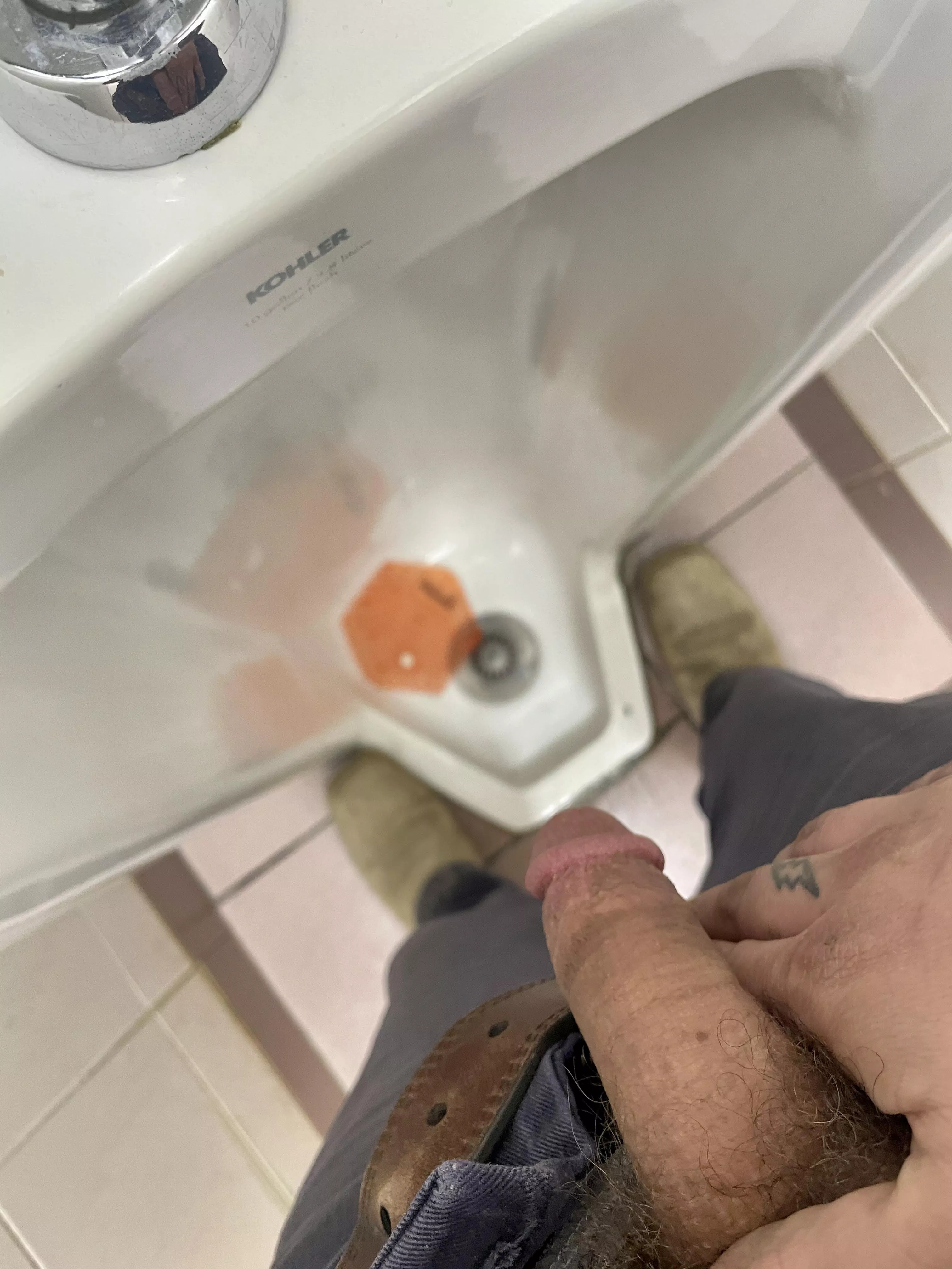 At the urinal