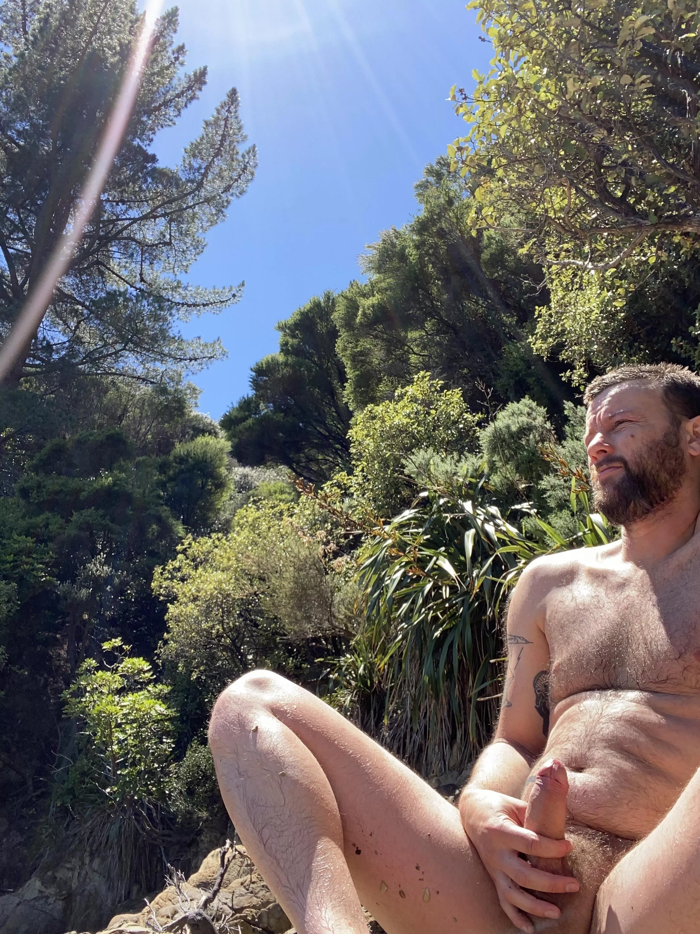 Beard and a boner on a beach by the bush