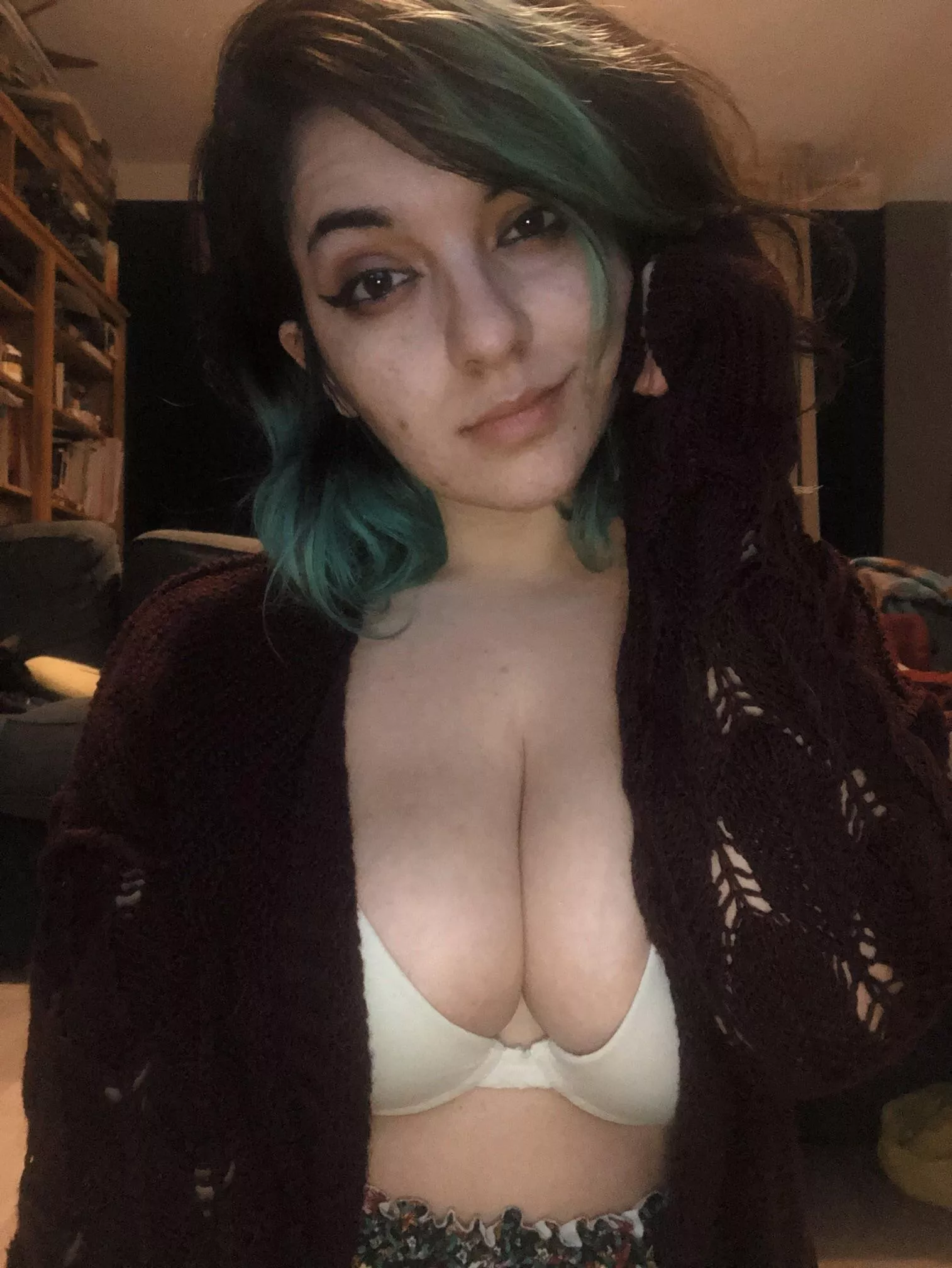 Chilling in a cozy cardigan and bra.