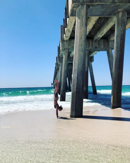 Hand stands on the beach π