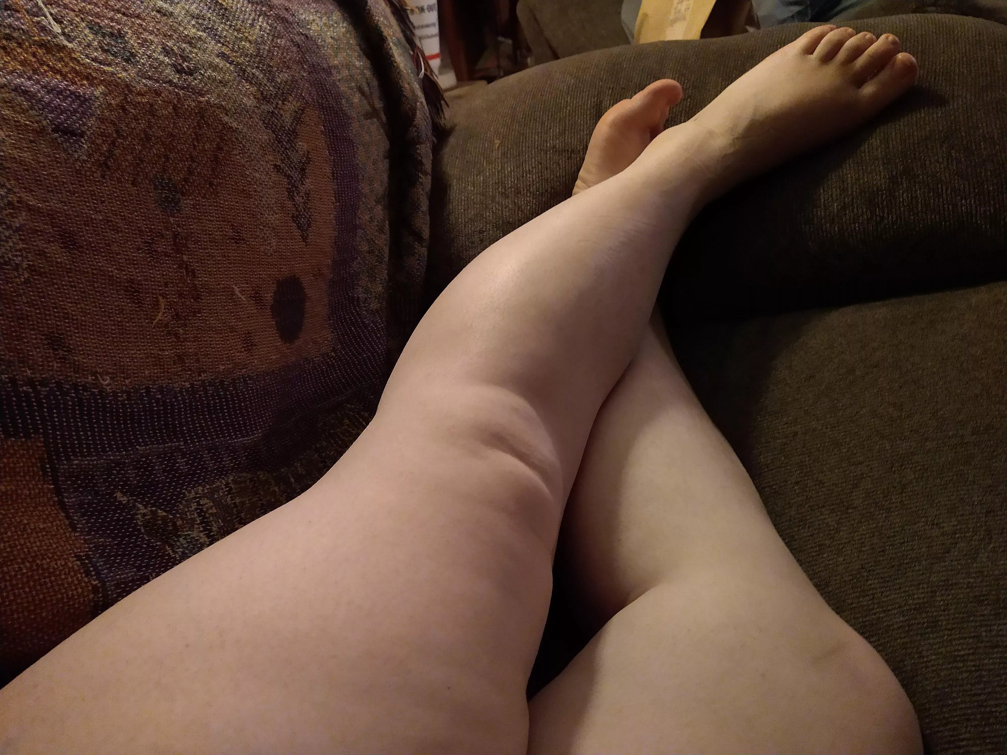 Laying on the couch. ?