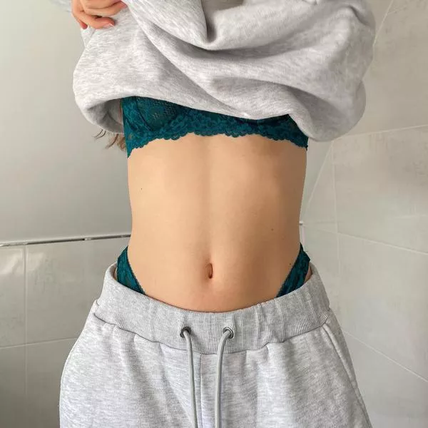 Lingerie peeking out from sweatsuit Lingerie peeking out from sweatsuit