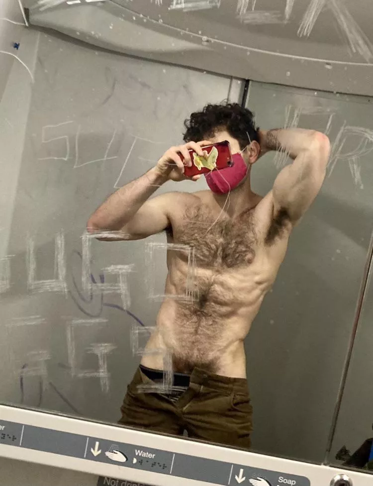 Mask on, shirt off. Public toilet, private fun