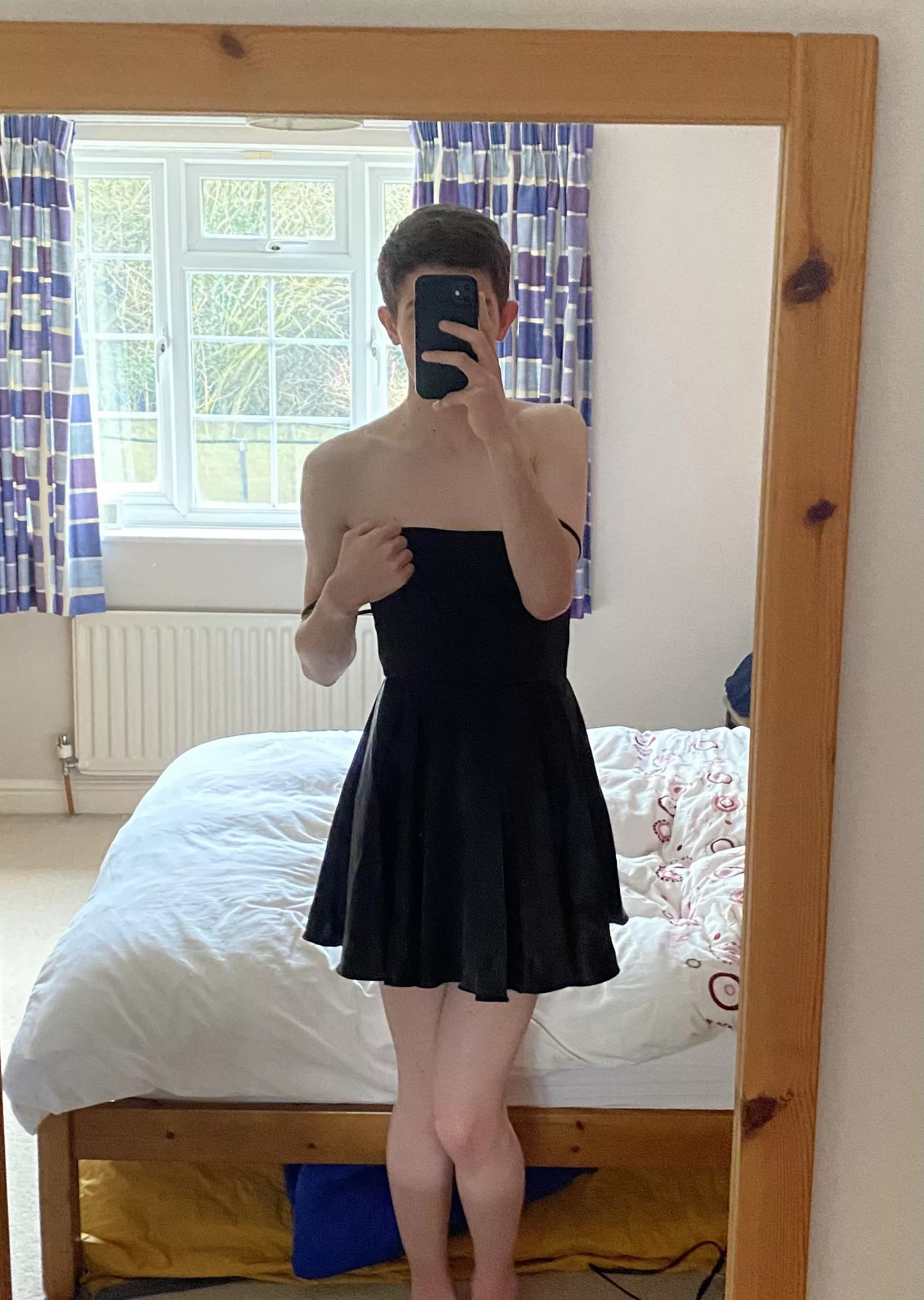Me being girly in front of the mirror in a black dress :)