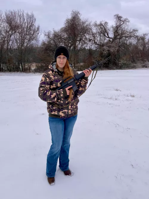 My fiancée with “her” Colt AR15 Sporter in the snow