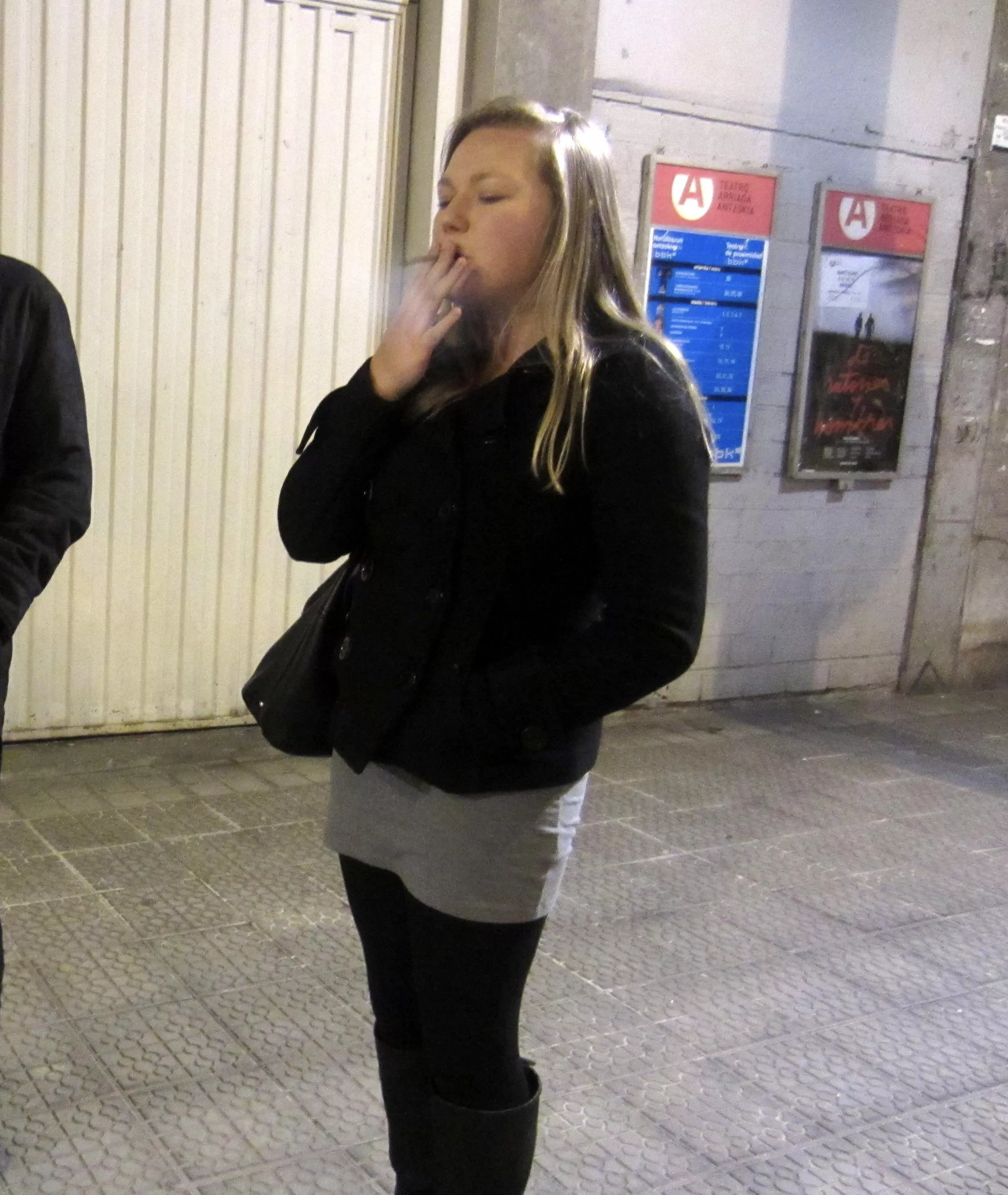 My girlfriend filling her lungs after a long flight. She really needed that nicotine!