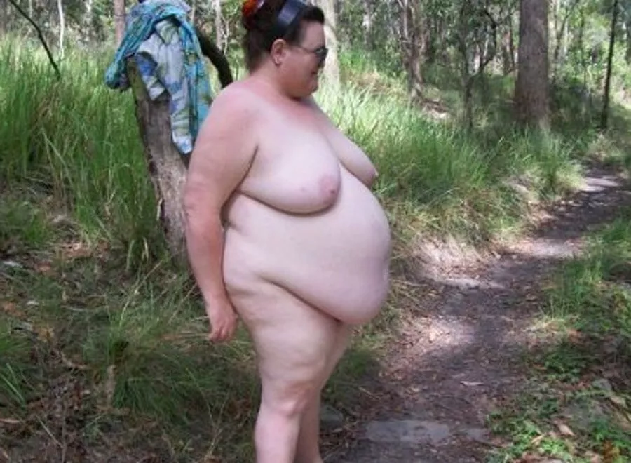 Nudist with a big belly on the nature trail Nudist with a big belly on the nature trail