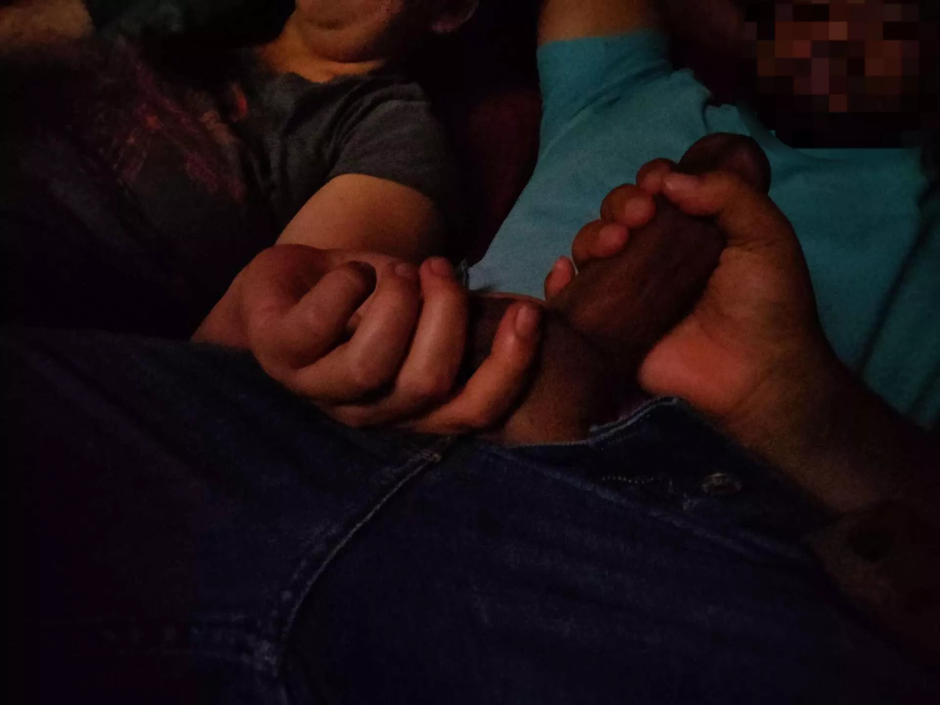 Two ladies playing with my dick in a theater.