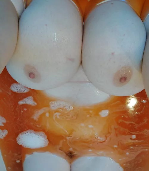 Two melons (f)loating in an orange tub (oc)