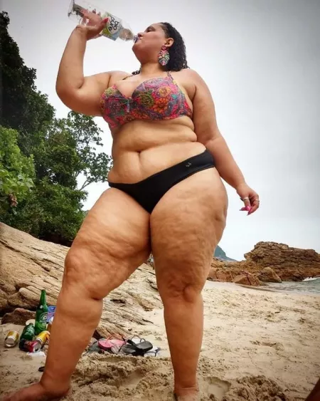 Woman Drinking A Soft Drink Has Cellulite On Her Thighs Woman Drinking A Soft Drink Has Cellulite On Her Thighs
